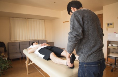 professional massage therapist treating patient in clinic